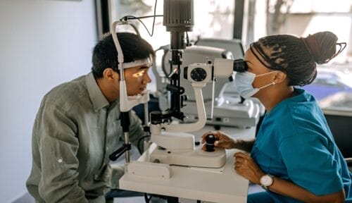 Woman ophthalmologist with male patient